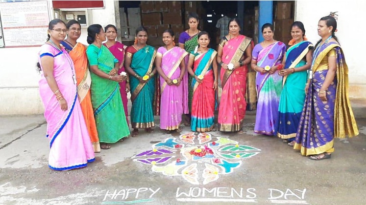 staff of Arvind Ltd. with rangoli